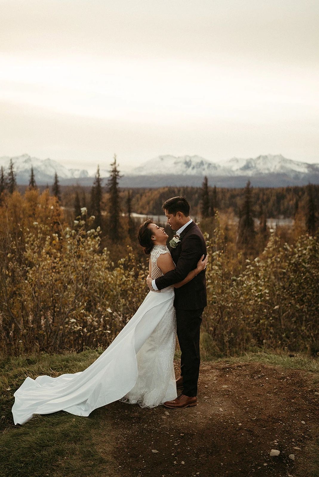 A couple exchanges vows during their Denali elopement ceremony, with Mount Denali as the backdrop.