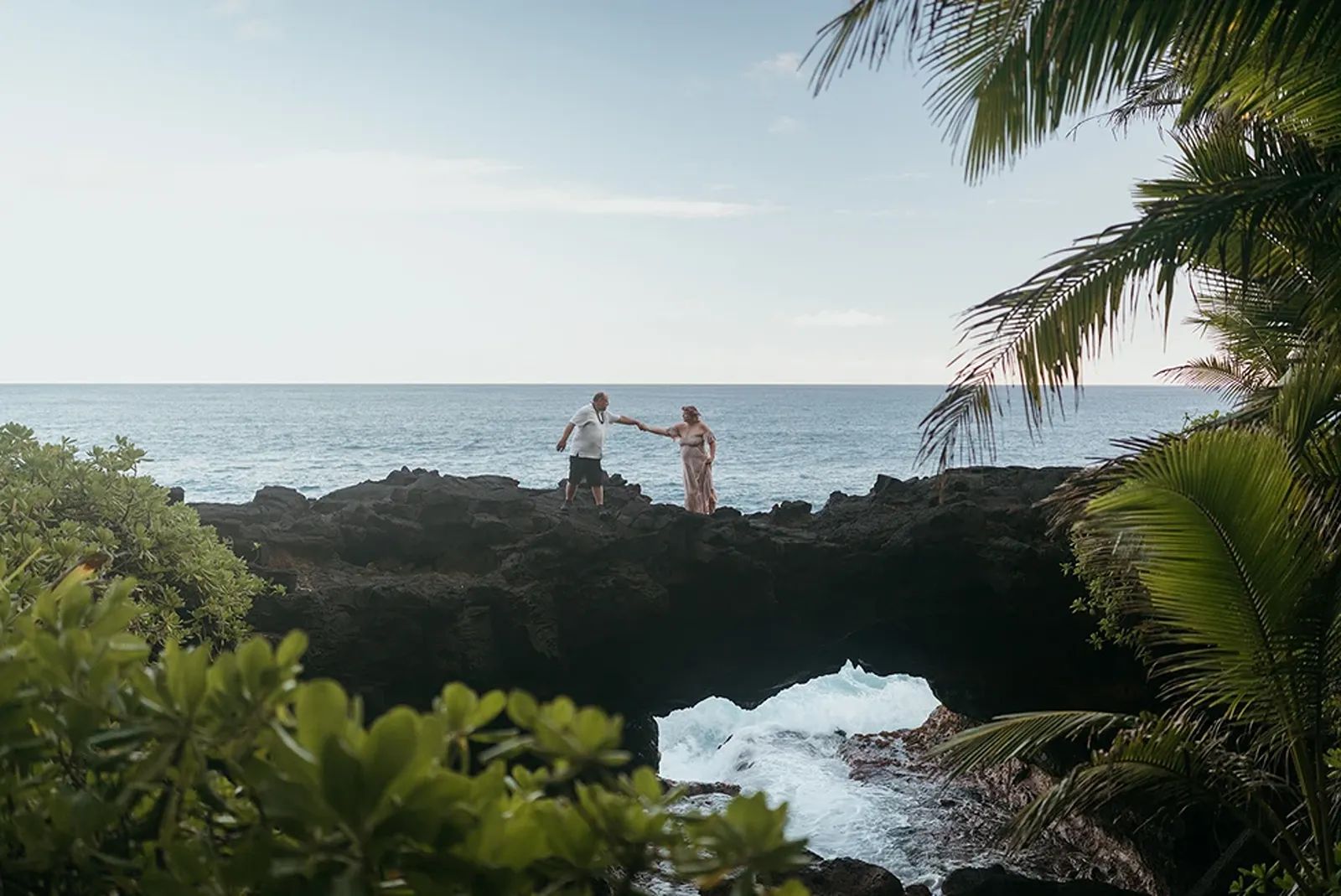 A couple exchanges vows in Hawaii on the Big Island with a dramatic ocean backdrop.